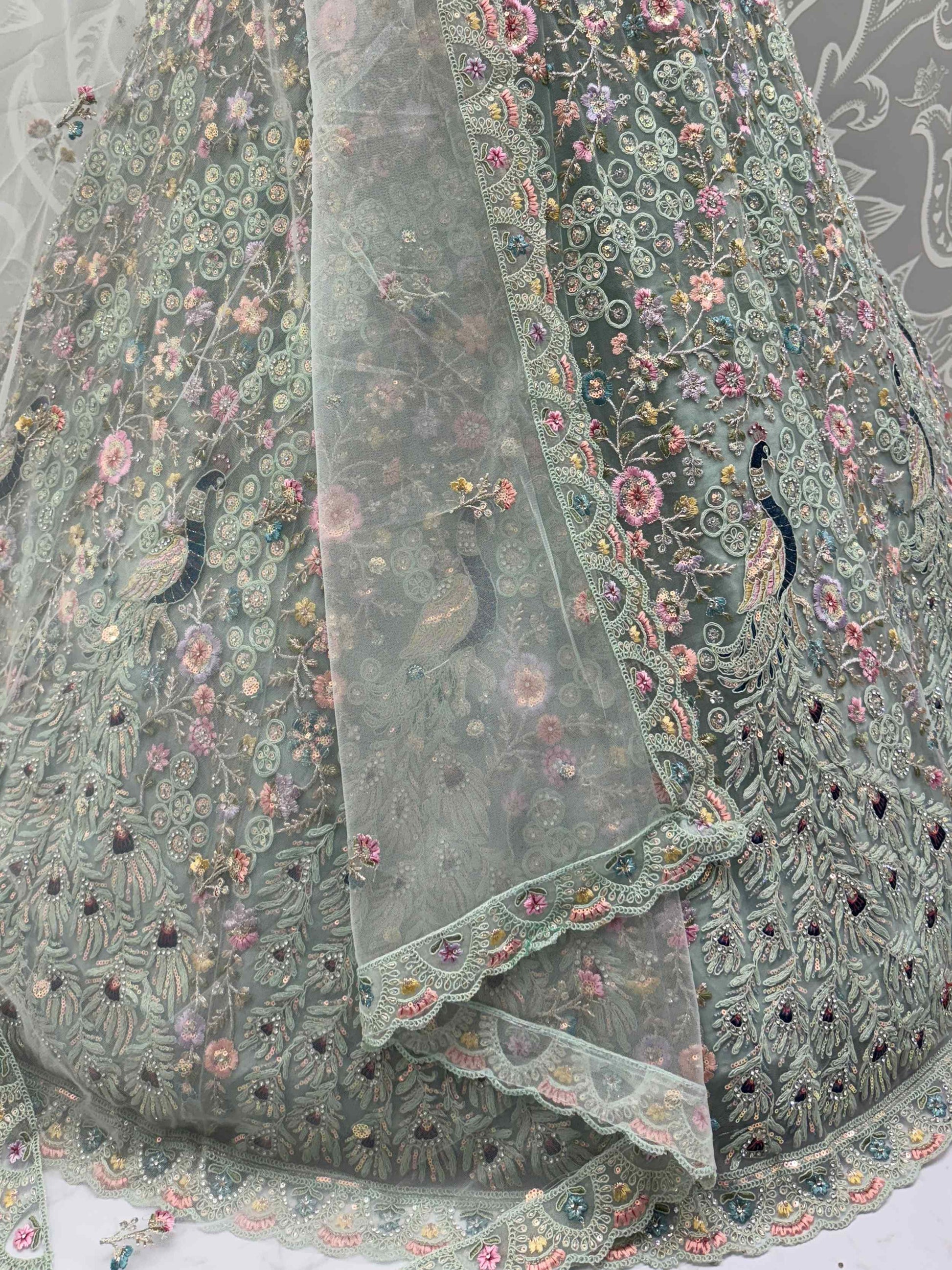 Dazzling Sky Blue Net Zari Embroidered Reception Wear Lehenga Choli